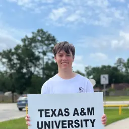 A photo of me holding a sign saying Texas A&M.